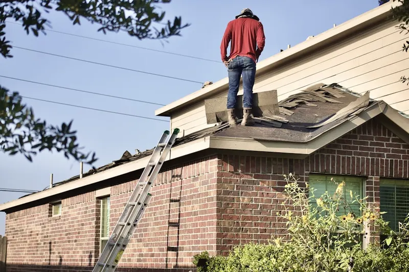 Professional roofer working on a residential roof in Overpeck